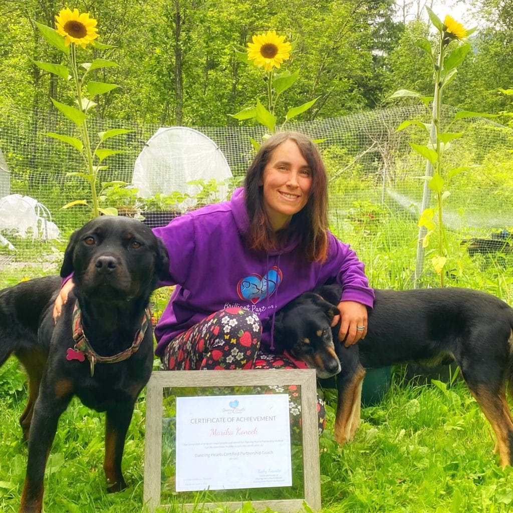 Coach Marika with her dogs in the garden